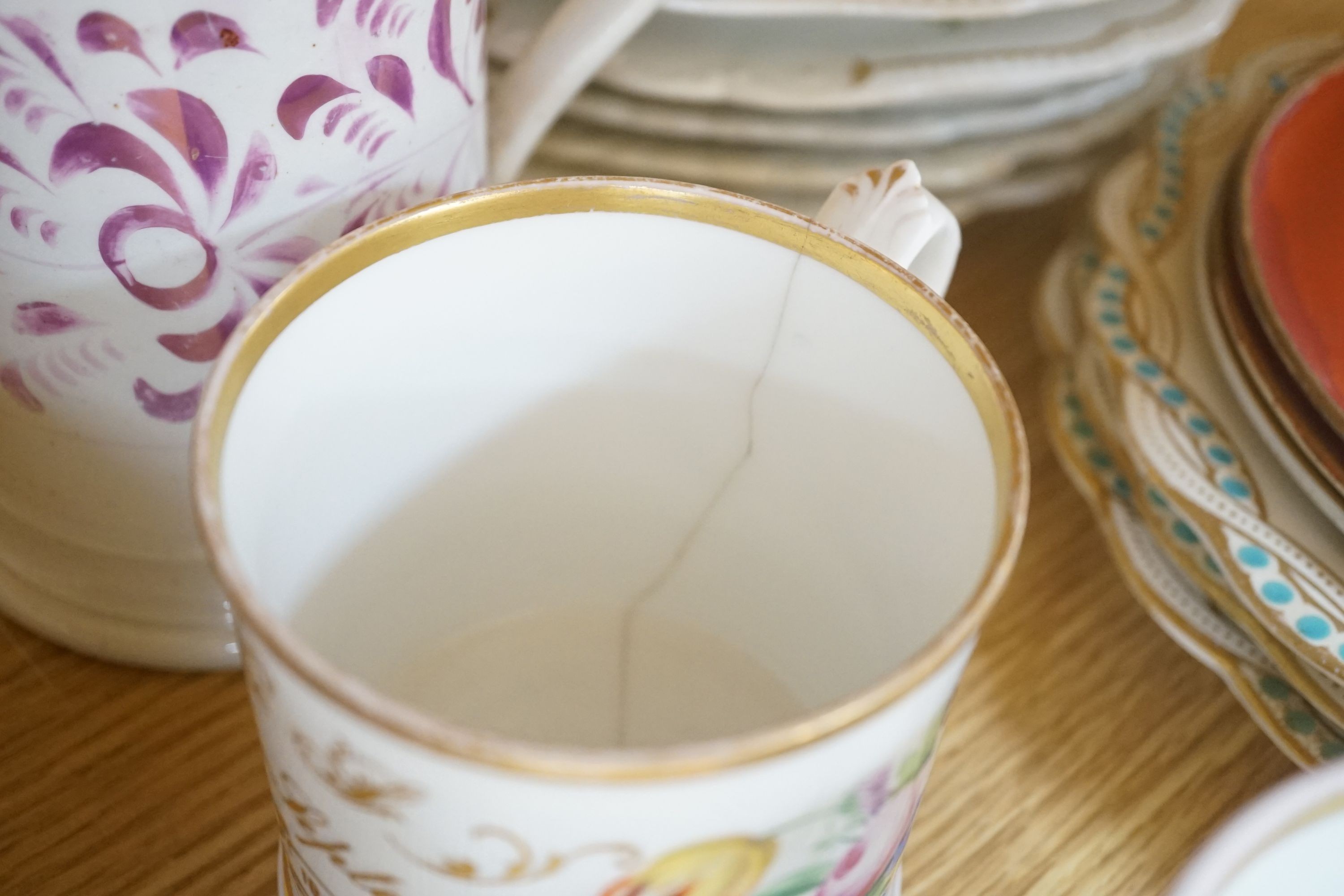 A collection of 19th century English porcelain plates and mugs and a Derby Cupid group, c.1775